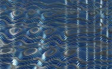 Abstract 3D surface of flowing blue wave patterns with reflective highlights, resembling rippling water or data waves