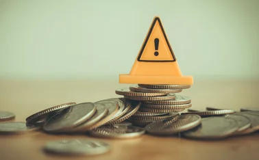 An error or failure sign atop a pile of currency