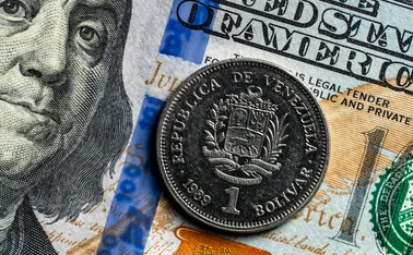 US dollar note and bolivar coin