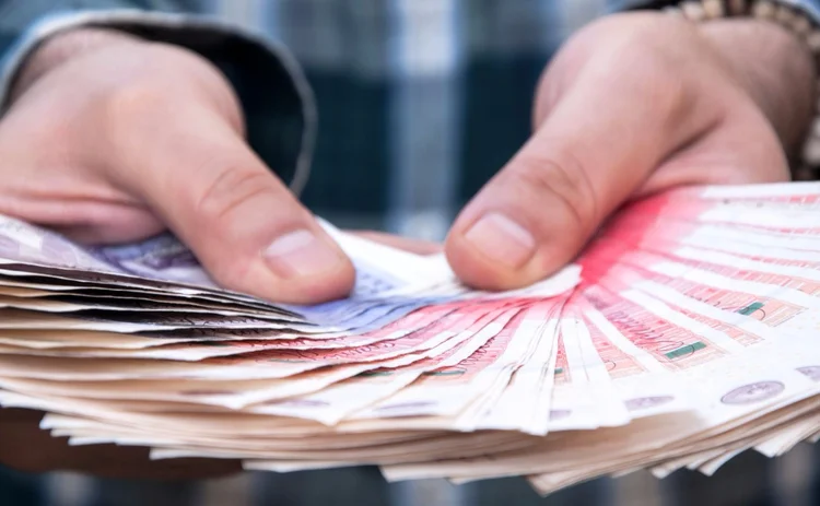 Hands holding cash Hands holding cash