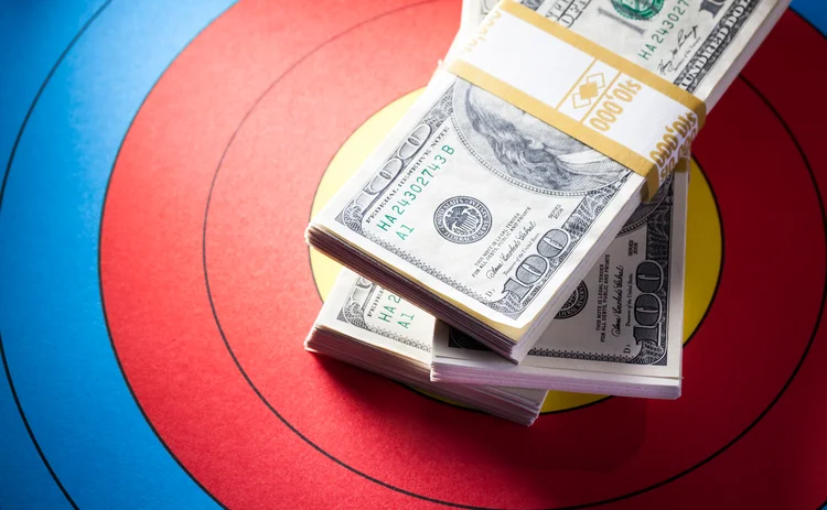 Pile of dollar notes on an archery target board