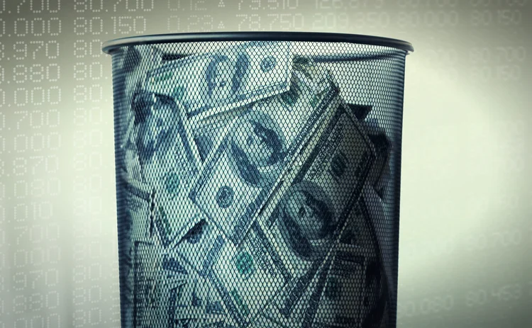 Cash-VM-Getty-511092827 Pile of dollars in a waste paper bin superimposed on a securities ticker background