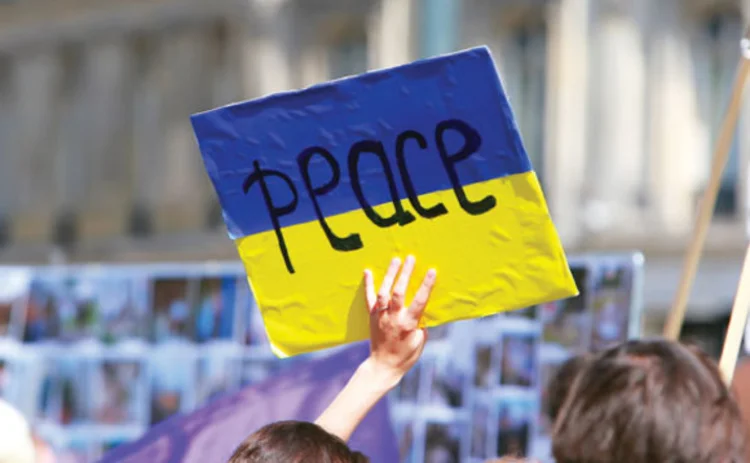A protestor in Ukraine holding a peace sign