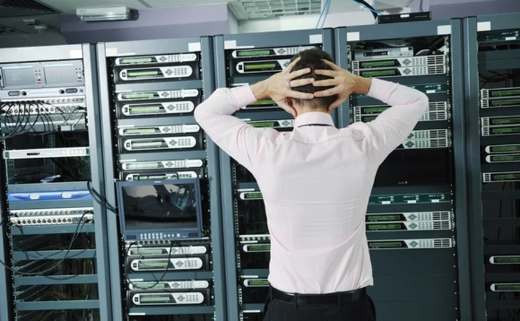 A man staring into a stack of racks in frustration