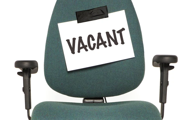 A chair with a vacant notice taped to it A chair with a vacant notice taped to it