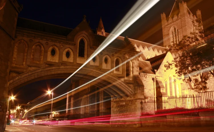 traffic-zooming-past-cathedral-at-night traffic-zooming-past-cathedral-at-night