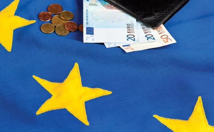 EU flag with euro notes and coins EU flag with euro notes and coins