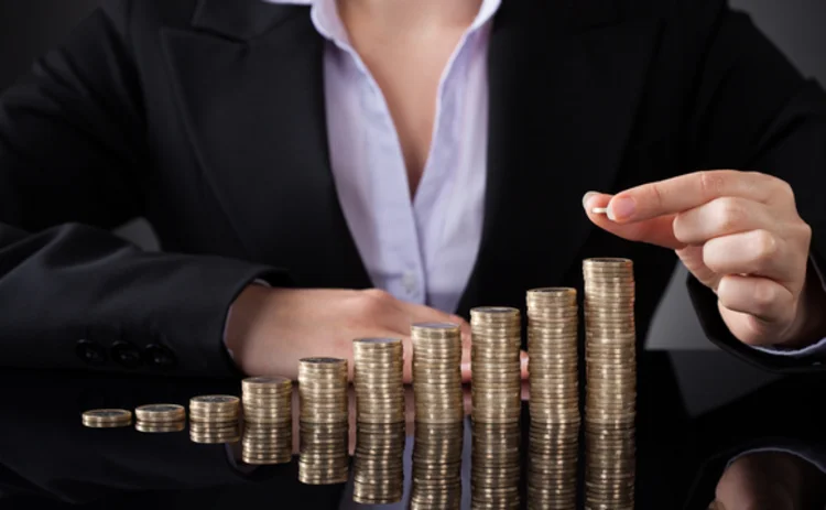businesswoman-coins-gold-stack
