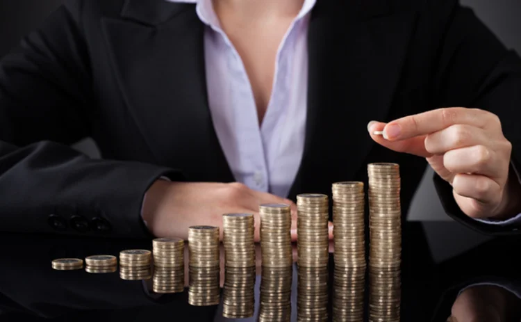 businesswoman-coins-gold-stack businesswoman-coins-gold-stack