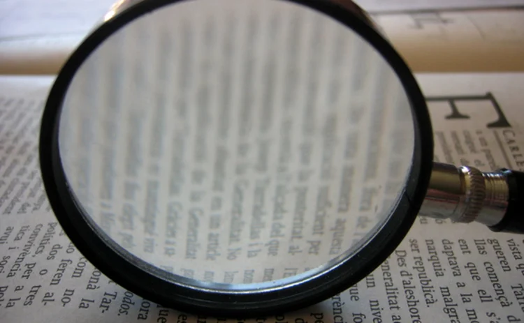 A magnifying glass and a book A magnifying glass and a book