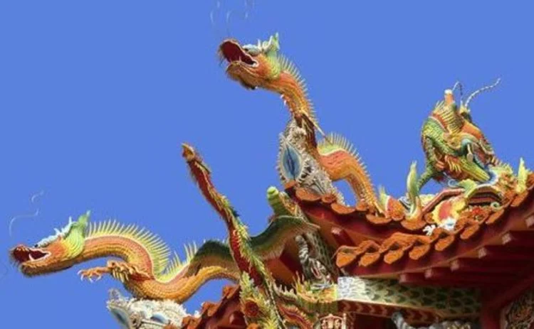 chinese-dragons-three-on-gate-top-orange-against-blue-sky chinese-dragons-three-on-gate-top-orange-against-blue-sky