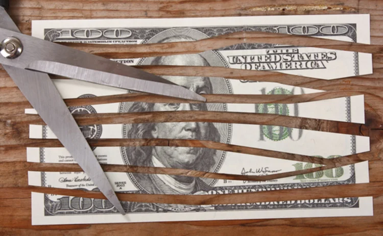 scissors cutting a dollar bill into strips scissors cutting a dollar bill into strips