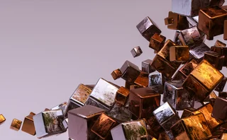 Abstract 3D composition of reflective metallic cubes in copper, bronze, silver and gold tones, clustered and floating diagonally across a soft lavender background