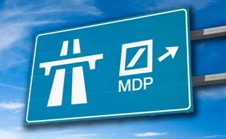 Motorway sign with a right turn-off signalled “MDP” beneath a Deutsche Bank logo
