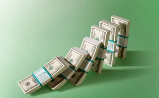 Bundles of dollars falling like dominoes