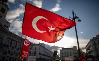Protestors waving a flag at a demonstration against political crackdowns against CHP