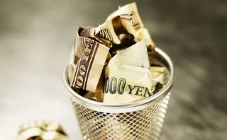 Yen and dollars in wastepaper basket