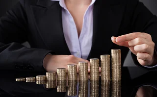 businesswoman-coins-gold-stack