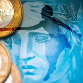 A couple jive dancing superimposed over Brazilian currency image