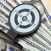 Dollar notes on a financil chart overlaid with a miniature target