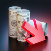 A red down arrow leaning against two rolls of US dollar notes 