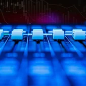 Mixing desk equalisers below a trading chart backdrop